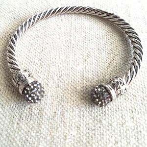 Silvertone twisted cable cuff bracelet with rhinestones.